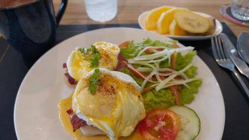 a plate of food with eggs and salad on a table at Bebeladan Beach Eco-Resort, The Last Indigenous Corner in El Nido