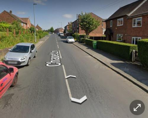 a street with cars parked on the side of the road at Midnight Stays in Manchester