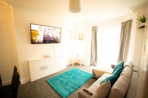 a living room with a couch and a fireplace at One BR Flat By Eason Stays Short Lets & Serviced Accommodation Lowestoft With Free Parking in Lowestoft
