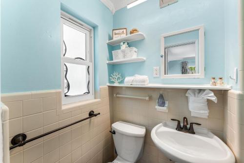 a bathroom with a sink and a toilet and a mirror at 1375 Bay Shore Drive in Cocoa Beach