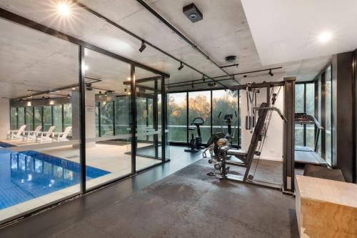 an image of a gym with a swimming pool at VAQUAY Belladonna In Abbotsford in Melbourne