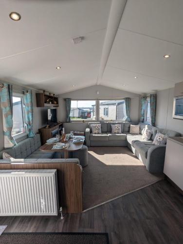 a large living room with couches and a table at Pet friendly holiday home located at Littlesea Holiday Park, In Weymouth, Dorset in Wyke Regis