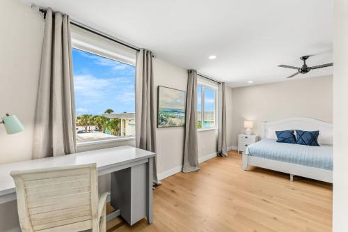 a bedroom with a bed and a desk and a window at 40 8th Avenue in Indialantic