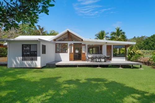 a small white house with a large yard at Adora Villa in Ewingsdale
