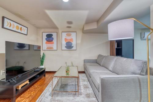 a living room with a couch and a table at Stay Portland - 1BR Historic Soul District Remodel in Portland