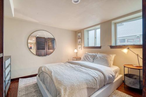 a bedroom with a large bed and a mirror at Stay Portland - 1BR Historic Soul District Remodel in Portland