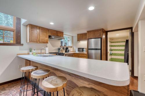 a kitchen with a large counter with stools at Stay Portland - 1BR Historic Soul District Remodel in Portland
