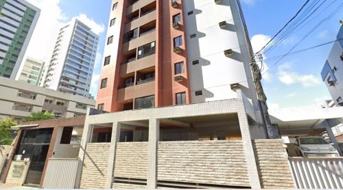 a tall building with a staircase in front of it at Apto imperial Cabo branco in João Pessoa