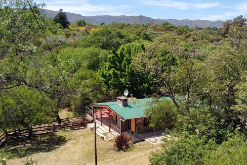 a house with a green roof in a forest at Vado Biguá in Valle Hermoso