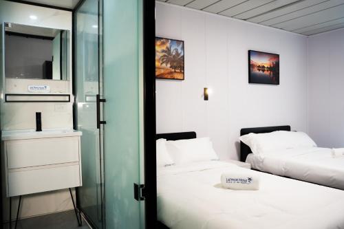 a room with two beds and a glass door at Hotel Laimoa in Apia