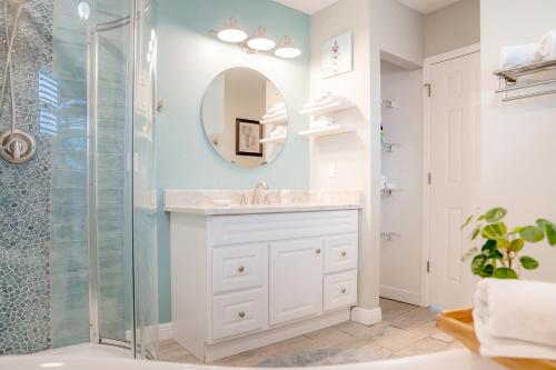 a bathroom with a sink and a shower at Cozy Coastal Cottages of Dunedin in Dunedin
