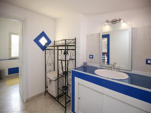 a bathroom with a sink and a mirror at Holiday home with sea view and large terrace in Castelsardo