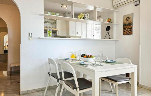 a white dining room with a white table and chairs at El Mirador De Calahonda in La Cala de Mijas