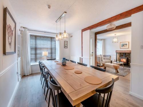 a dining room with a large wooden table and chairs at Warrington House-Uk48465 in Thornton Dale