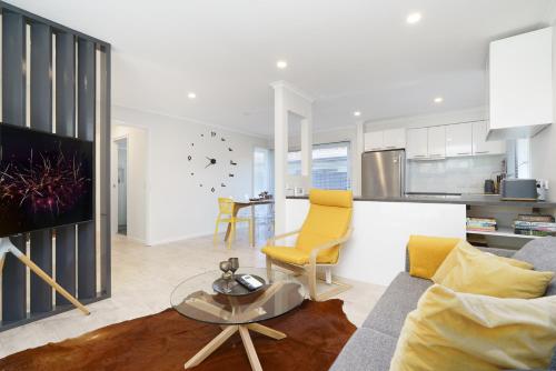 a living room with a couch and a table at Stylish 3Bedroom Escape in South Canberra - Hosted by Canstay in Kambah