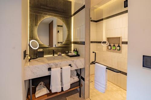 a bathroom with a sink and a mirror at Pueblo Bonito Vantage Centro Histórico Mazatlán in Mazatlán