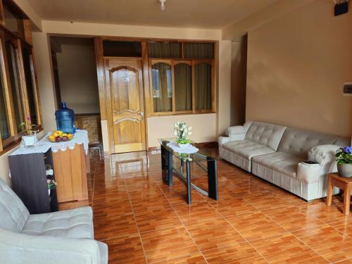 a living room with two couches and a table at Echevarria Oxapampa in Oxapampa