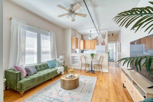 a living room with a green couch and a kitchen at Historic Mississippi - Live Music & Local Shops in Portland
