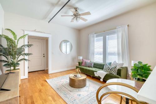 a living room with a green couch and a window at Historic Mississippi - Live Music & Local Shops in Portland