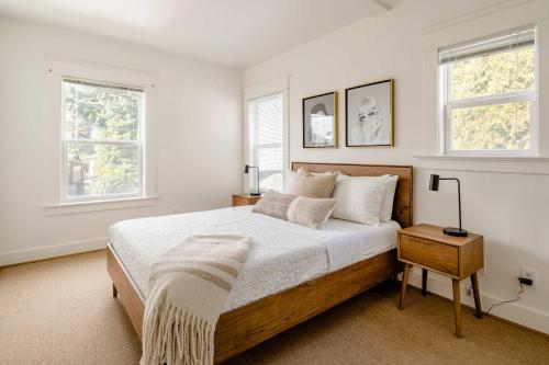 a bedroom with a large bed and two windows at Hipster Vibe Apartment - Food Carts & Live Music in Portland