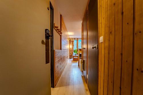 a hallway of a house with a door open at Ski in and out heart of Val Thorens - 1BR Sleeps 4 people in Val Thorens