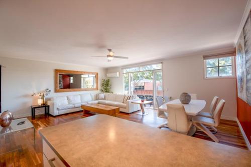 a living room with a couch and a table at Spacious City Apartment - Walk to Casino, MCEC & MCG in Melbourne