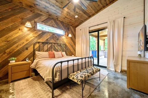 a bedroom with a bed and a wooden wall at Nectars Ridge - Heated Pool, Hot Tub, Ping Pong, Arcade in Broken Bow