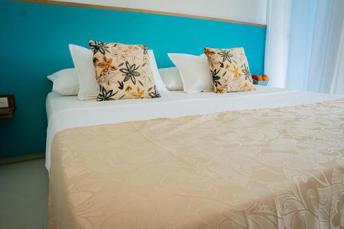 a bedroom with a large bed with pillows at La Puerta del Ángel LOW COST in Ricaurte