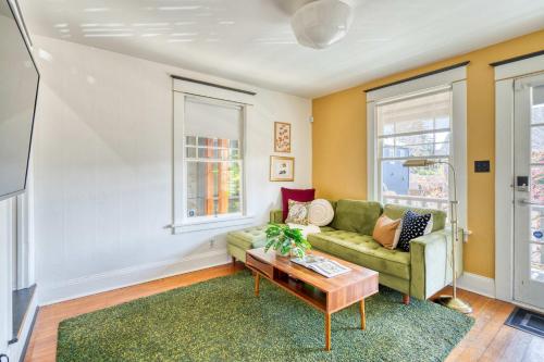 a living room with a couch and a table at Overlook Gem - Steps from Mississippi in Portland