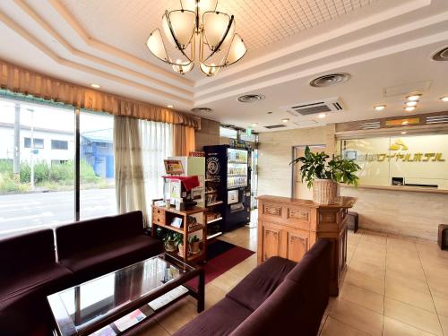 a living room with a couch and a large window at Suzuka Royal Hotel in Suzuka