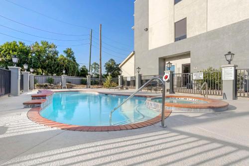 a swimming pool with a slide in front of a building at Comfort Suites Houston NW - Vintage Park in Houston