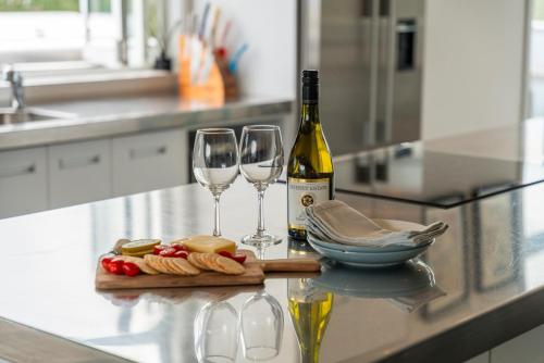 a bottle of wine and two wine glasses on a counter at Kinloch Lookout in Kinloch