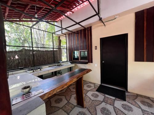 a bathroom with a tub and a large window at Hotel "Casa Las Lolas" in Xpujil