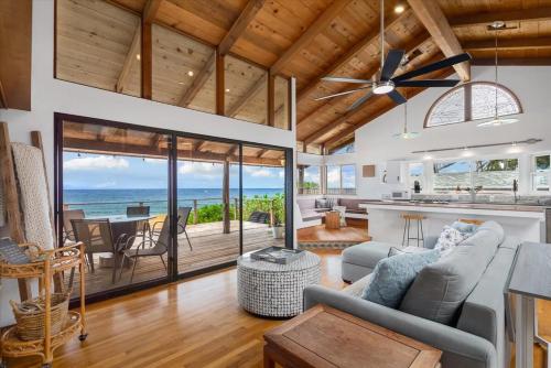 an open living room with a view of the ocean at Oceanfront Pipeline Miracle in Pupukea