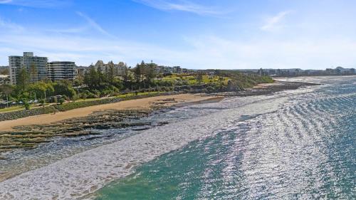 an aerial view of a beach with buildings and the ocean at Ocean Vista Retreat - Walk to Mooloolaba & Alex in Mooloolaba