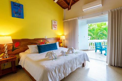 a bedroom with a bed with two shoes on it at Hotel Mar Rey in Tamarindo