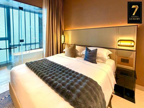a bedroom with a large bed with a large window at 7Stonez Luxury ANTARA RESIDENCE Genting Highlands in Genting Highlands