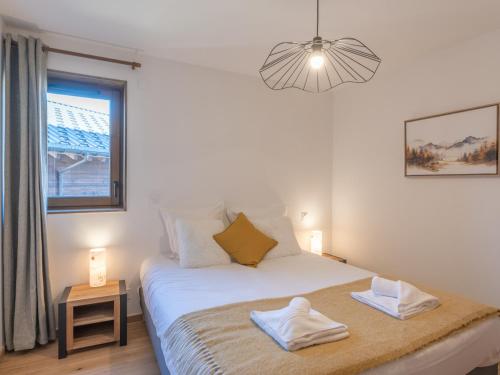 a bedroom with a bed with two towels on it at Appartement neuf avec balcon et accès direct aux pistes, 3 chambres, Alpe d'Huez - FR-1-645-94 in L'Alpe-d'Huez