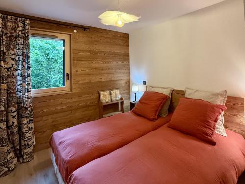 two beds in a bedroom with a window at Appartement 3 Chambres avec Terrasse et Parking à Arâches-la-Frasse, Animaux Bienvenus - FR-1-836-41 in Les Carroz d'Araches