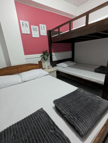 two beds in a room with two bunk beds at EMILIEZ PLACE in Baguio