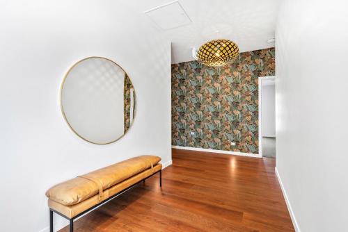 a room with a bench and a mirror on the wall at Deluxe Queen Room at Wolfe Street in Whangarei