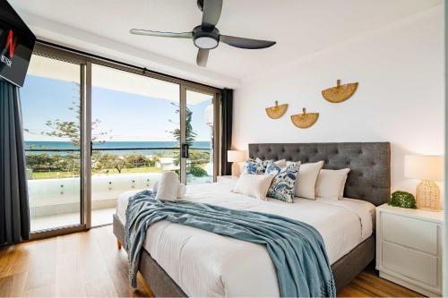 a bedroom with a bed with a view of the ocean at Shara Seaside Oasis - Alex Beach 3BD Apartment in Alexandra Headland