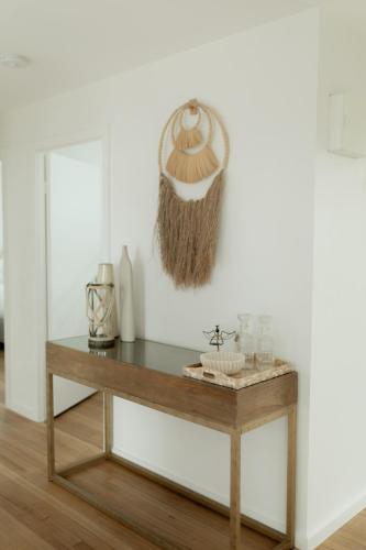 a table with a hat hanging on a wall at California 'Luxe Boho' with Pool in Echuca