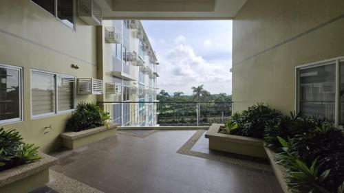 a balcony of a building with plants on it at Urban Oasis Cozy Studio at Berkeley Suites South Forbes Nuvali in Silang