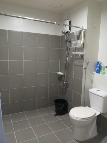 a bathroom with a white toilet and a shower at Serene Suites Condo unit in Bacoor