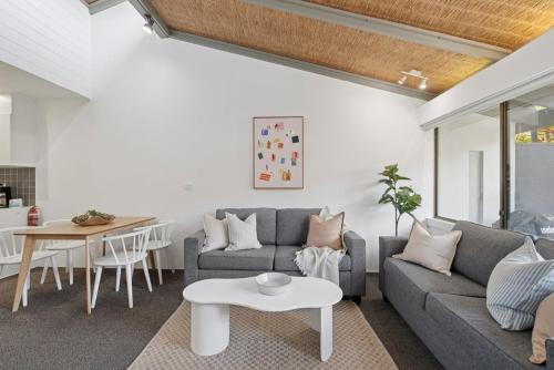 a living room with a couch and a table at Hibiscus Villa - Beachfront, 2 pools, Tennis, Restaurant in Kororo Basin