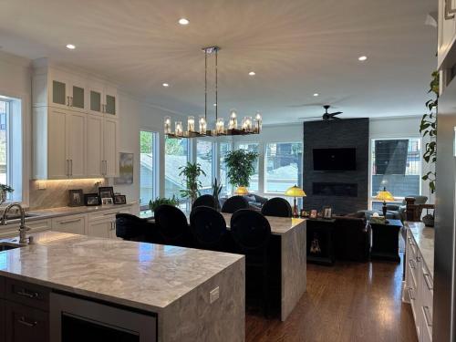 a kitchen with a island with black chairs in it at The Lyons' Den in Chicago