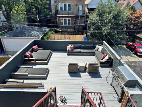 a patio with couches and chairs on a roof at The Lyons' Den in Chicago