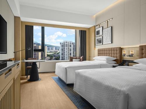 a hotel room with two beds and a large window at Four Points by Sheraton Fuzhou, Jin’an in Fuzhou