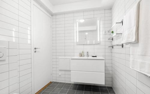 a white bathroom with a sink and a mirror at Newly renovated 3 BedRm, Spacious 80m sq, comtemporary Apartment in Central Trendy Oslo-Grunnerlokka in Oslo